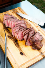 Rumpsteak wird auf Holzbrett geschnitten
