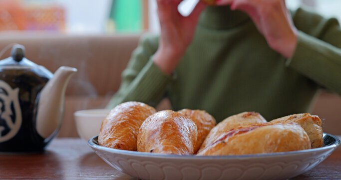 Woman eating traditional uzbek meal - somsa in cafe