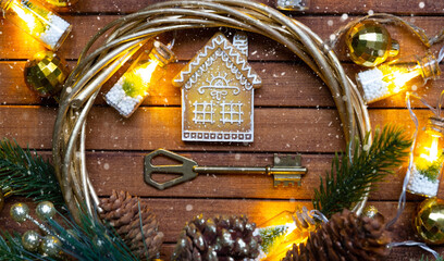 Key to house with a keychain tiny home on wooden background with Christmas decor layout. Gift for...