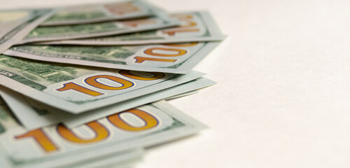 Close-up of $100 bills. On the right is a space for advertising text