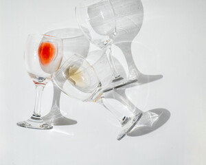 Wine of different varieties in glasses on a white background. Fashionable hard shadows from glasses.