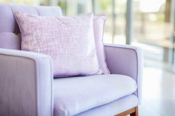 Pastel perfection: Purple pillows adorn an armchair, a cozy cushioned chair rests by a window. Dreamy hues create a serene scene.