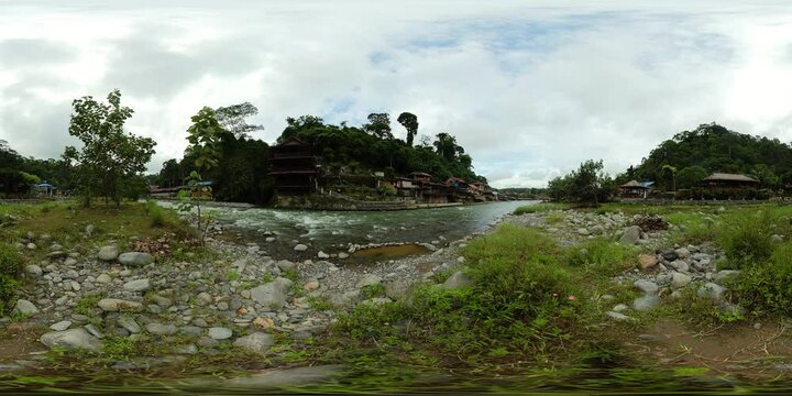 Sumatra, Indonesia - Sep 8, 2022: River townscape view of Bukit Lawang before a ecotourism jungle hike in Gunung Leuser National Park. Virtual Reality 360.