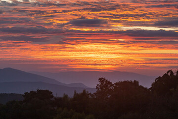 Amazing colorful sunrise sky over the rainforest mountains at Ob Luang natinoal park, Chiangmai, Thailand