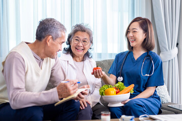 Senior couple get medical advice visit from caregiver nutritionist at home while having suggestion on fresh vegetable meal for healthy eating on probiotic and better digesting system concept