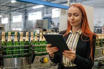 Portrait of a Female Engineer Specialist Using Tablet Computer at the Factory of Sparkling Wine....