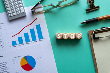 There is wood cube with the word STOP. It is an abbreviation for STOP as eye-catching image.
