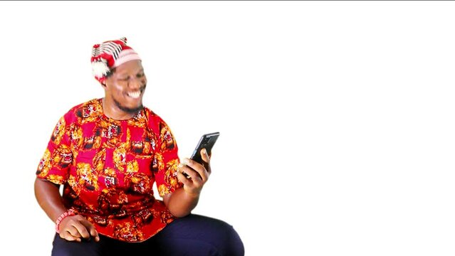 Celebrating win sitting down with mobile phone news in a close up. African, Black, African-American male model