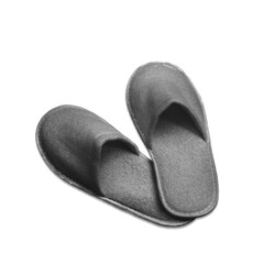 A pair of gray disposable textile slippers on a transparent and white background. PNG. View from...