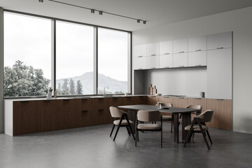 Gray kitchen corner with cabinets and table