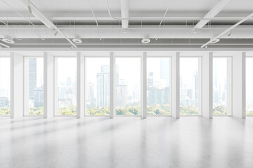 Stylish empty office interior with light concrete floor and panoramic window