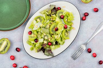 Green summer salad of kiwi and lettuce.