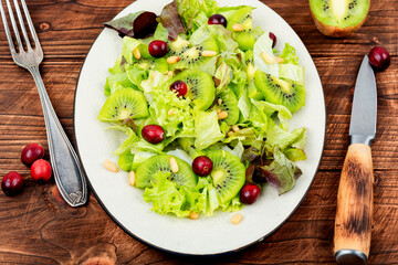 Green vegan salad of kiwi and herbs.
