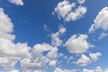 Naklejka na ściany i meble sunny weather with white clouds on a blue sky background