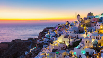 sunset by the ocean of Oia Santorini Greece, a traditional Greek village in Santorini with...