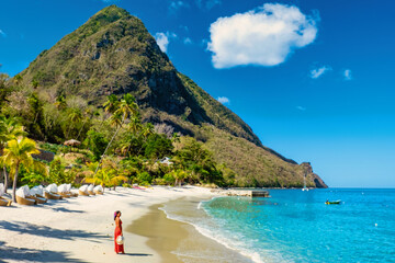St Lucia Caribbean, woman on vacation at the tropical Island of Saint Lucia Caribbean ocean, Asian women in a red dress on the beach - obrazy, fototapety, plakaty