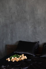 Tulip flowers in bedroom interior with black bed