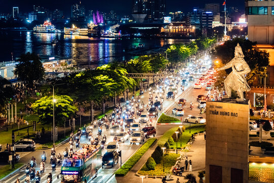 View of Me Linh roundabout with heavy traffic near Bach Dang waterbus station port and Saigon river at blue hour