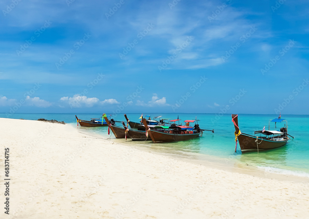 Wall mural thai traditional wooden longtail boat and beautiful sand beach in thailand. traveling concept.