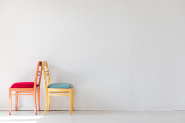 Two vintage chairs in the interior of a white room