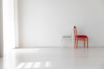 Two vintage chairs in the interior of a white room