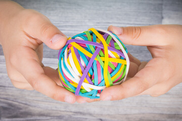 Preschooler hands with ball of rubber bands or erasers. Development of kids motor skills,...