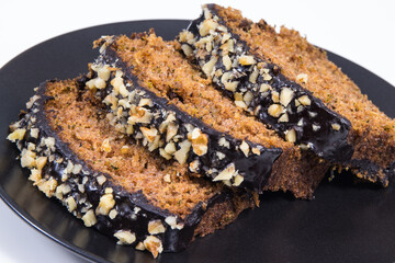Pieces of zucchini dough with nuts and raisins. White background