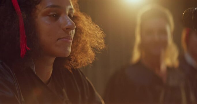 African-American female college or university graduate giving a speech on stage - Powered by Adobe