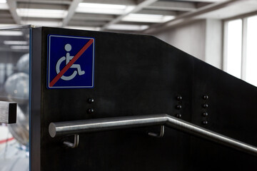 The wheelchair sign is crossed out near the handrail next to the stairs. Prohibition on wheelchair...