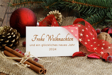 Weihnachtskarte: Weihnachtsgruß auf einer Karte mit Schleife und Weihnachtsdekoration. Frohe...