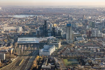 Fotobehang Aerial view city Rotterdam with residential area and railway station © Kruwt