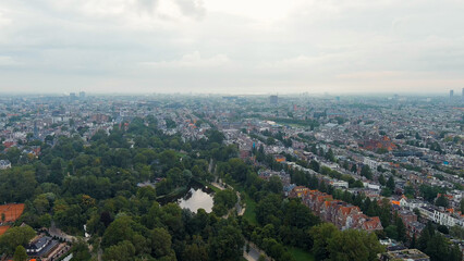 Fototapeta na wymiar Amsterdam, Netherlands. Vondelpark. Panoramic view of the city in summer in cloudy weather, Aerial View