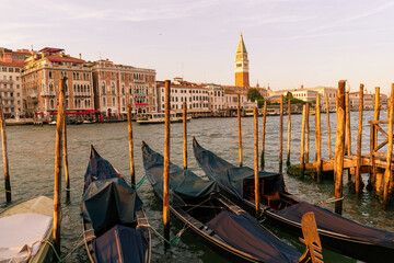 canals in old city of Venice landscape with gondolas, italian palaces and the bell tower of san...