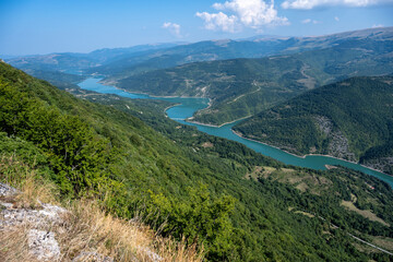 Naklejka na ściany i meble The Kozji Kamen viewpoint offers a beautiful view of Lake Zavojsko, the meanders of the Visocica River and mountain peaks. Serbia near Pirot.
