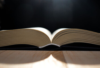 falling light on a single open book
