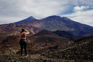 Hiker girl looking at Teide volcano from Samara trail, Tenerife, Canaries, Spain