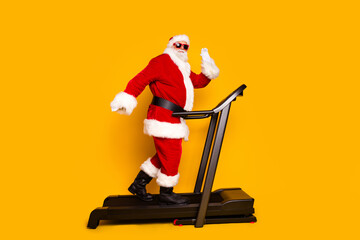 Full length profile portrait of sporty grandfather santa workout treadmill arm waving hi prepare...