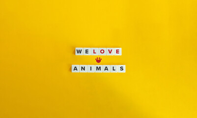 We Love Animals Text and Concept Image. Alphabet Letter Blocks on Yellow Background. Minimal...
