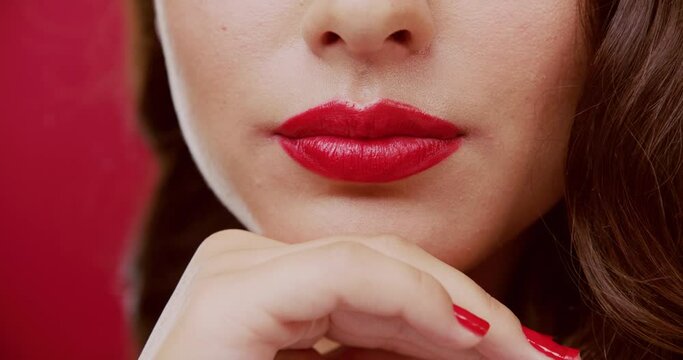 Woman, closeup and lipstick for kiss in studio, color and romance for cosmetics with emoji by red background. Girl, model and lips for symbol, icon and sign with zoom, mouth and change with flirt