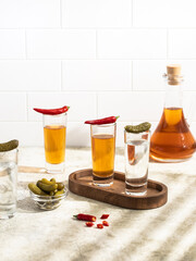 Tequila shots, vodka, whisky, rum. Red chilli pepper. 