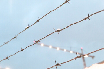 Close up of barded wire against sky