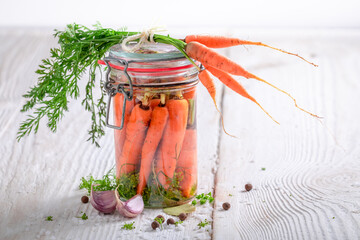 Preparation for pickled carrots with garlic, bay leaf and dill.