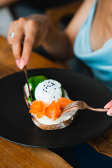 toast with red fish toast with egg woman eat toast hand toast on the black plate food black plate 