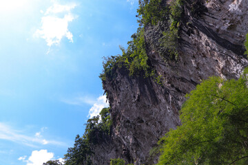 View from bottom of cliff. mountain peak and clear sky, green tree with white clouds. Important tourist attractions of Thailand. natural phenomenon. cloud sky in background.