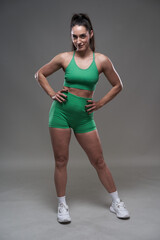 Fototapeta na wymiar Hispanic girl fitness model on gray background
