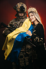 A couple in love at dawn during a battle in the smoke holds the flag of Ukraine in their hands. The...