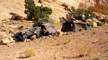 Abandoned mid-century car with many bullet holes in the desert that has been used for target practice for decades