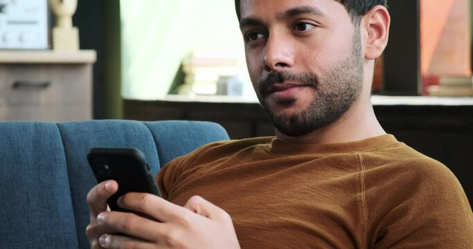 Man looks into the fridge while engaged in a phone conversation. His multitasking reflects the juggling of daily responsibilities, balancing communication and household tasks.