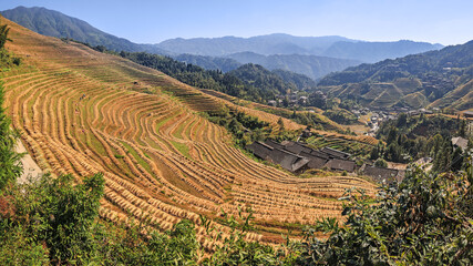 Panorama landscape of Long Ji Terrace (Dragon Bone Terrace) in autumn season with traditional houses in the valley
