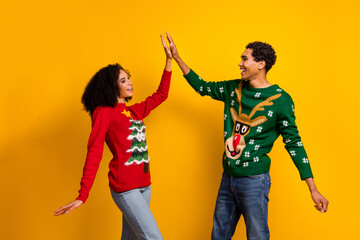 Photo of good mood excited lady guy wear new year ugly print sweaters clapping high five isolated...